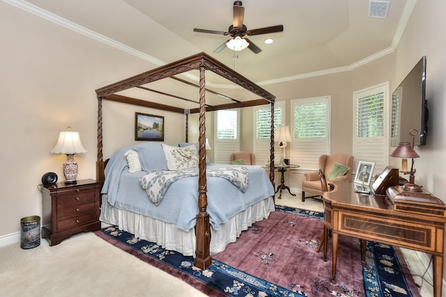 bedroom with ornamental molding, ceiling fan, carpet, and a tray ceiling