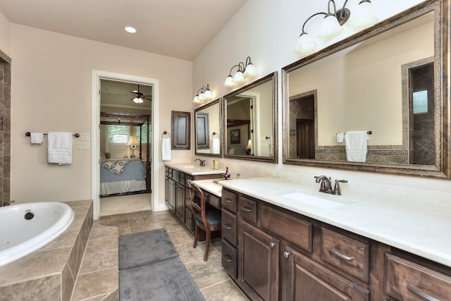 bathroom featuring ceiling fan, vanity, tiled bath, and tile flooring