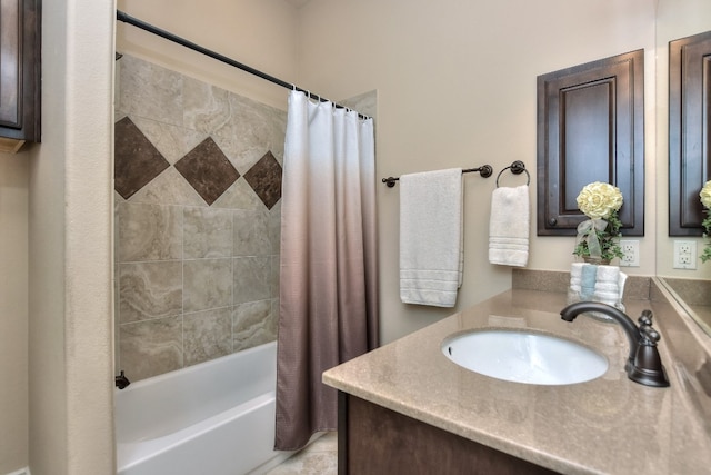 bathroom with vanity with extensive cabinet space and shower / bath combo