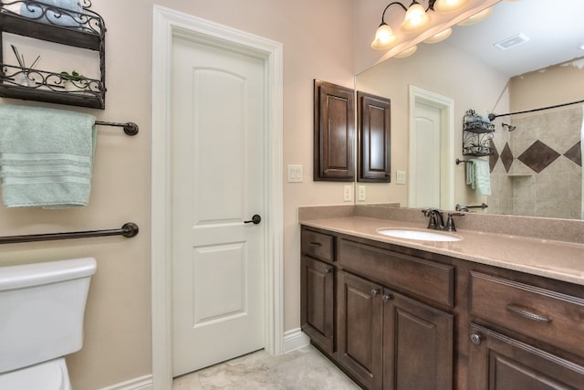 bathroom with vanity, tile floors, and toilet