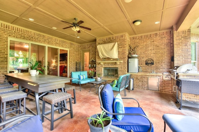 view of patio with area for grilling, ceiling fan, and an outdoor kitchen