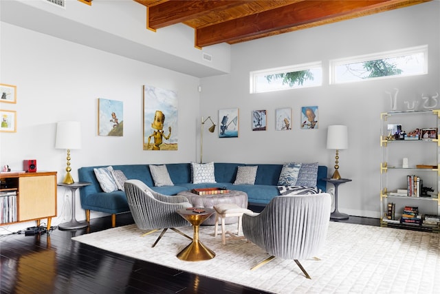 living room featuring hardwood / wood-style floors and beamed ceiling