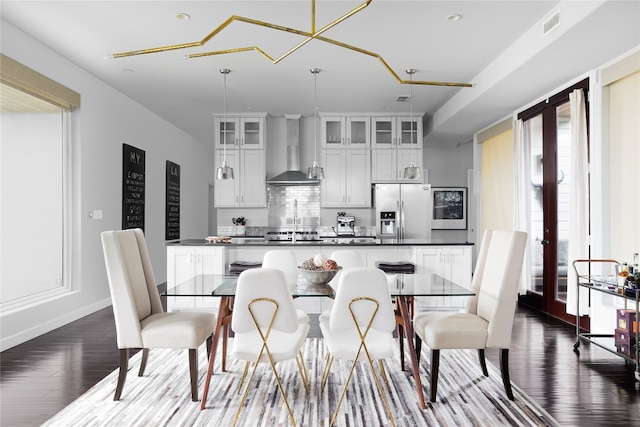 dining room featuring french doors and dark hardwood / wood-style flooring