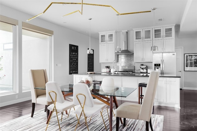 dining room with sink and dark hardwood / wood-style floors