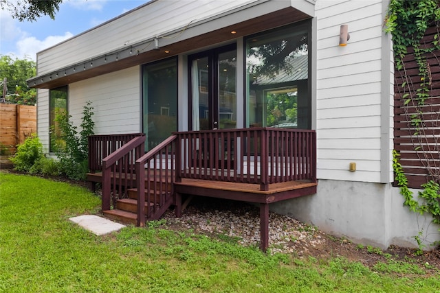 exterior space with a wooden deck and a lawn