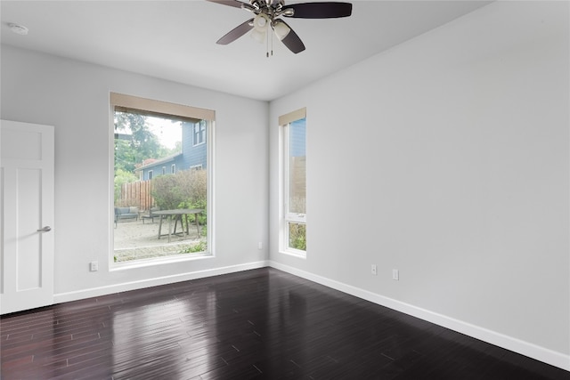 empty room with hardwood / wood-style floors and ceiling fan