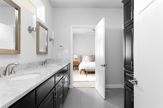 bathroom with dual sinks, oversized vanity, and tile floors