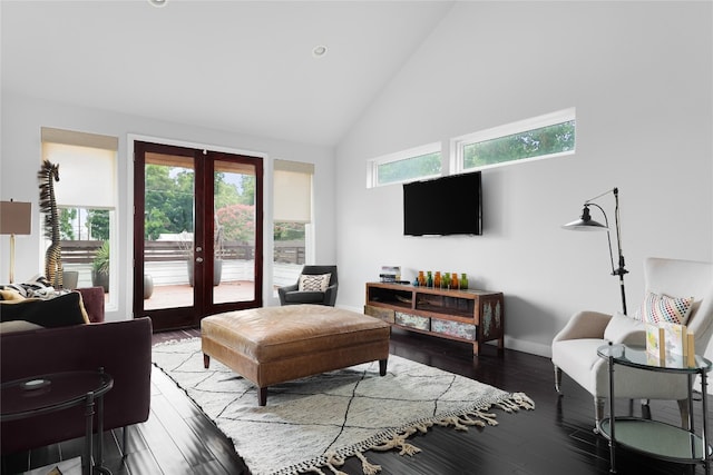 living room with a wealth of natural light, hardwood / wood-style floors, french doors, and high vaulted ceiling