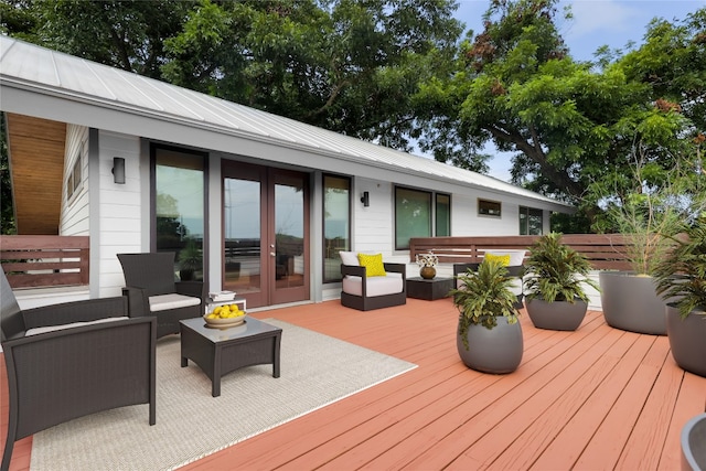 wooden deck with french doors and an outdoor hangout area