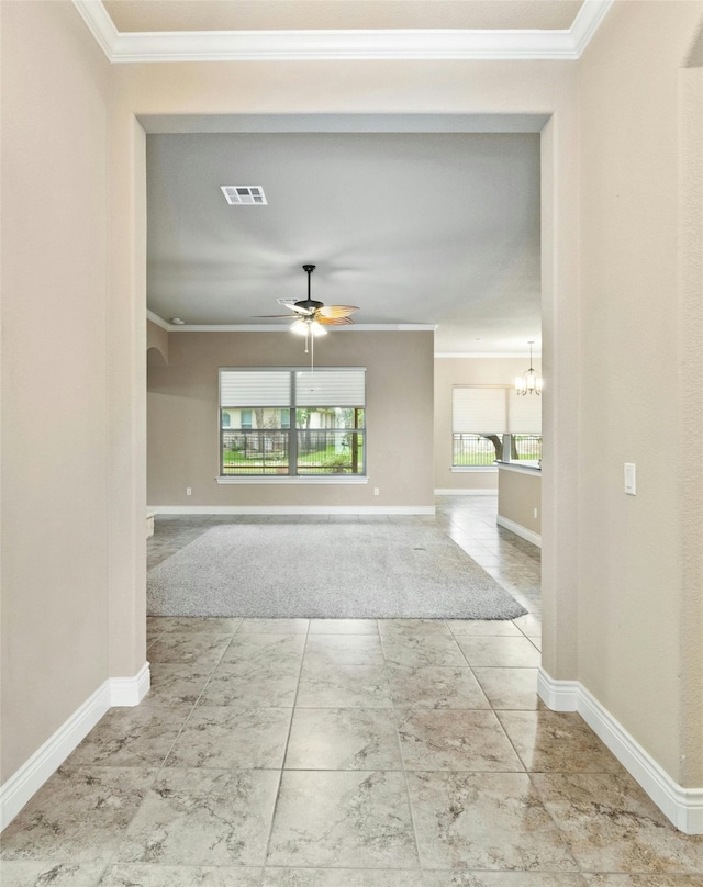 hall with a chandelier, tile patterned flooring, and ornamental molding