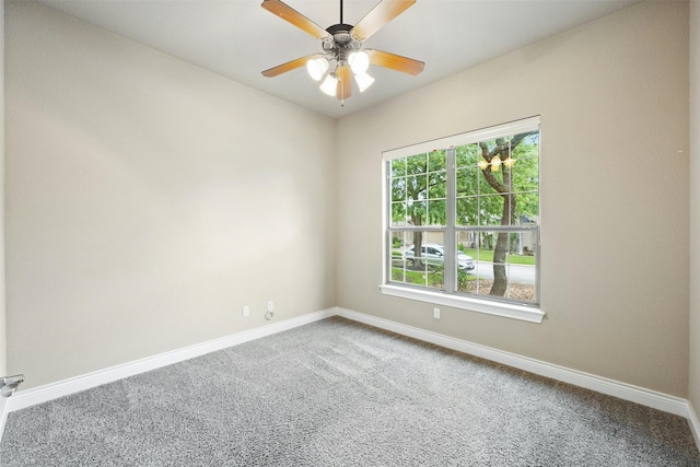 carpeted spare room featuring ceiling fan