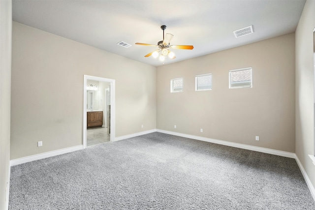 carpeted spare room with ceiling fan