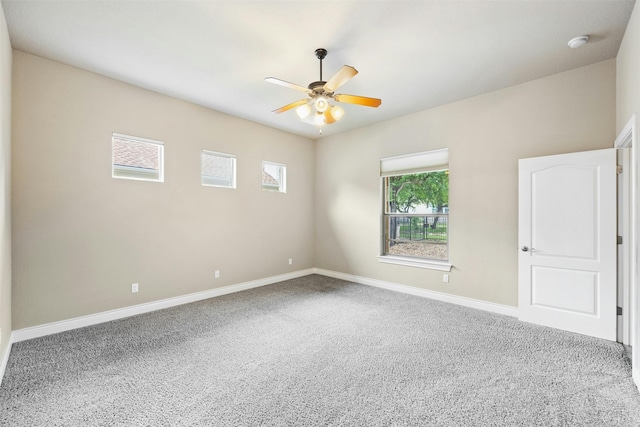 spare room featuring ceiling fan and carpet