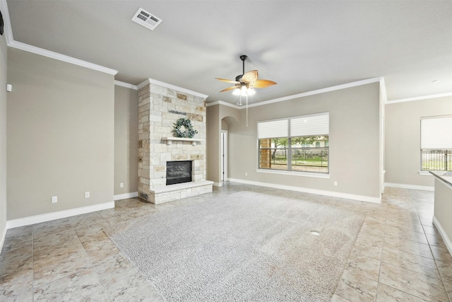 unfurnished living room with ceiling fan, a healthy amount of sunlight, a stone fireplace, and ornamental molding