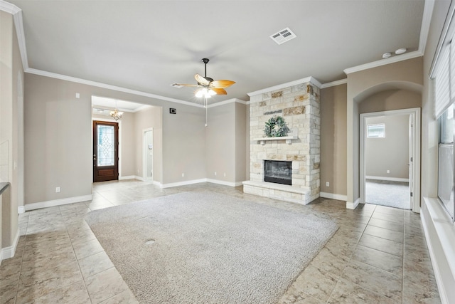 unfurnished living room with ceiling fan with notable chandelier, light tile patterned flooring, a stone fireplace, and ornamental molding