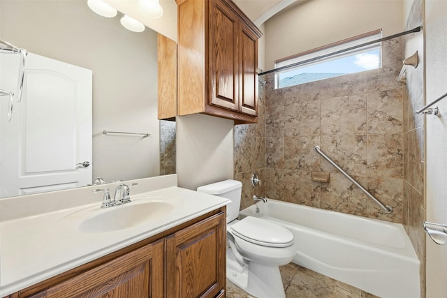 full bathroom featuring vanity, tiled shower / bath combo, and toilet