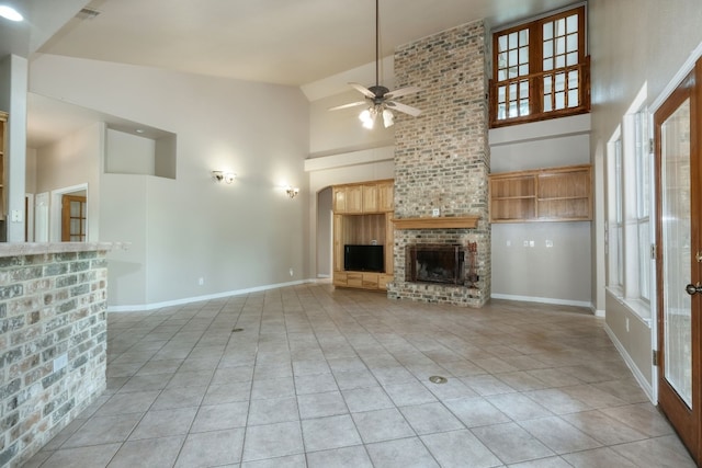 unfurnished living room with high vaulted ceiling, light tile floors, and a fireplace