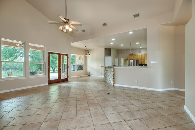 unfurnished living room with french doors, ceiling fan, high vaulted ceiling, and light tile floors