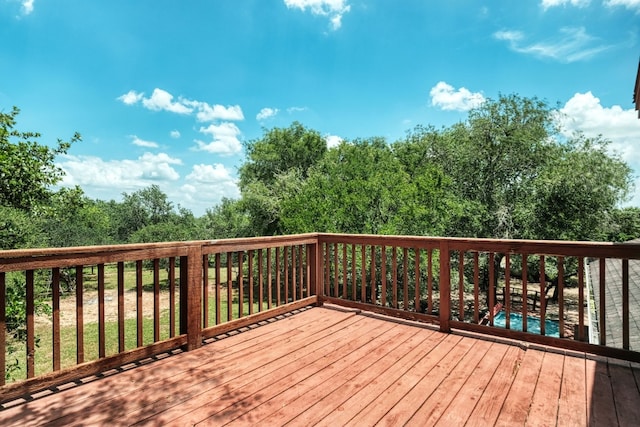 deck featuring a swimming pool