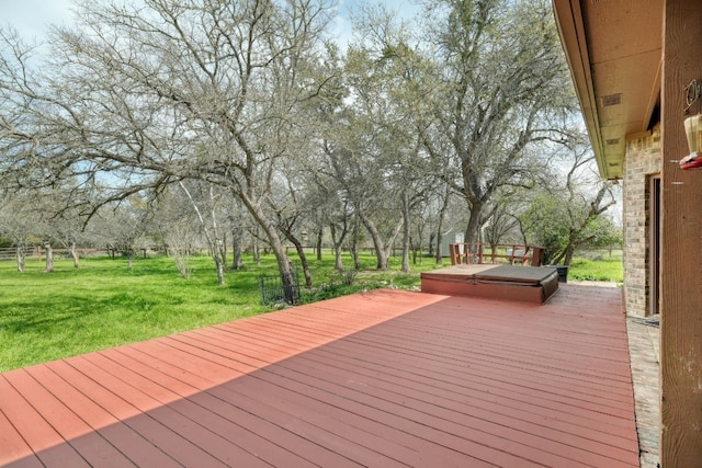 deck with a covered hot tub and a lawn