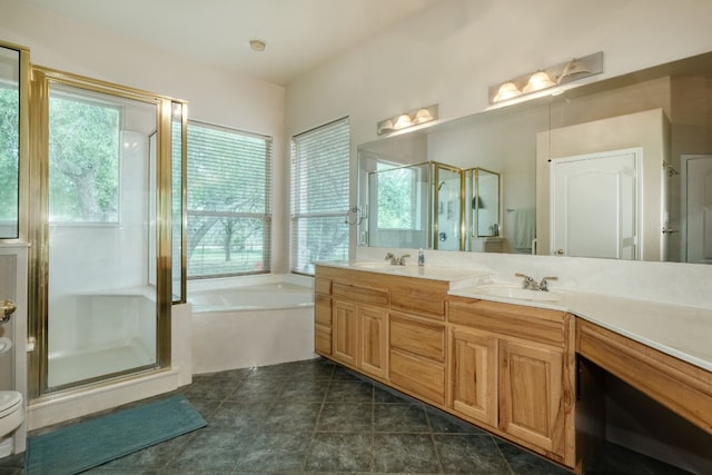 bathroom featuring plenty of natural light, tile floors, separate shower and tub, and dual vanity