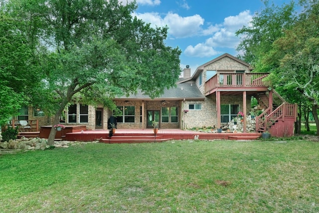 back of house featuring a yard and a wooden deck