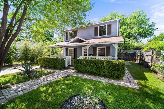 view of front of property with covered porch and a front yard