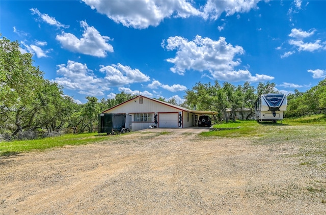 exterior space featuring a carport, an outdoor structure, and a garage