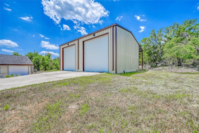 garage featuring a lawn