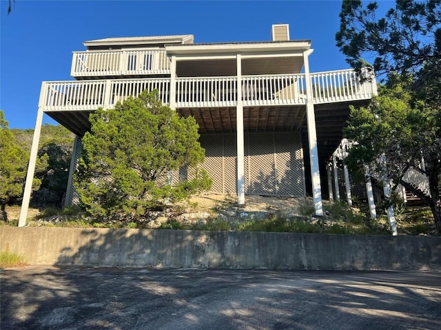 exterior space featuring a wooden deck and a chimney