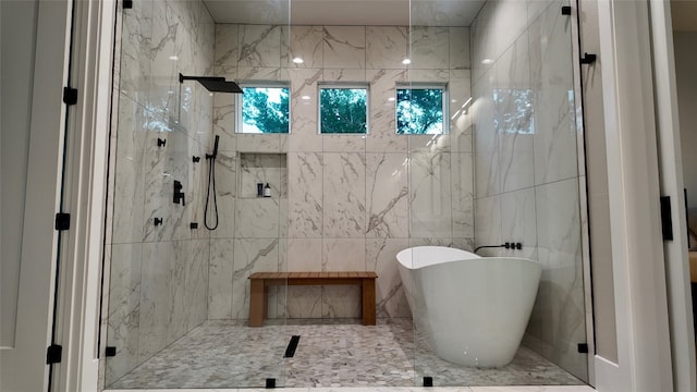 bathroom featuring tile walls and an enclosed shower