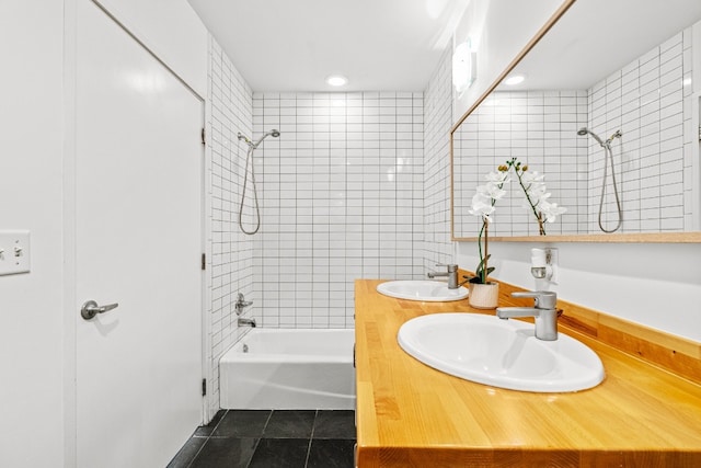 bathroom with tiled shower / bath, vanity, and tile patterned floors