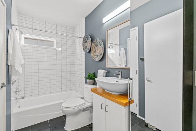 full bathroom featuring tile patterned flooring, tiled shower / bath combo, vanity, and toilet