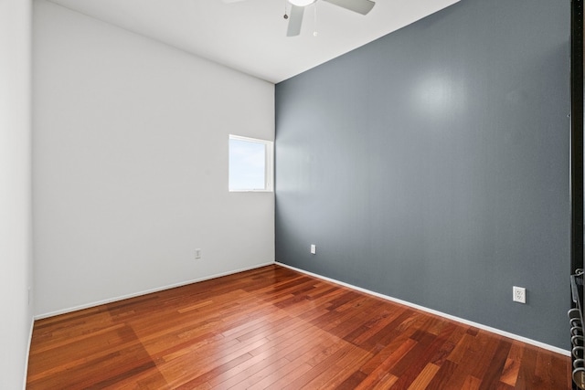 empty room featuring ceiling fan and hardwood / wood-style floors