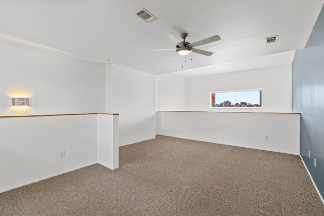 spare room with ceiling fan and carpet flooring