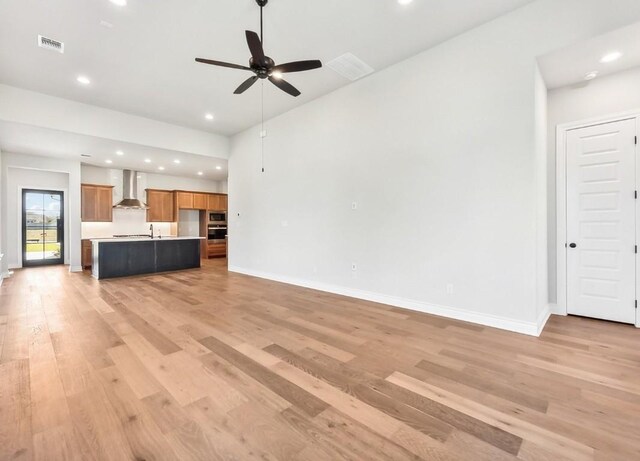226 Flora Springs Cv, Liberty Hill, TX 78642 - unfurnished living room with light wood-style floors, a ceiling fan, baseboards, and recessed lighting