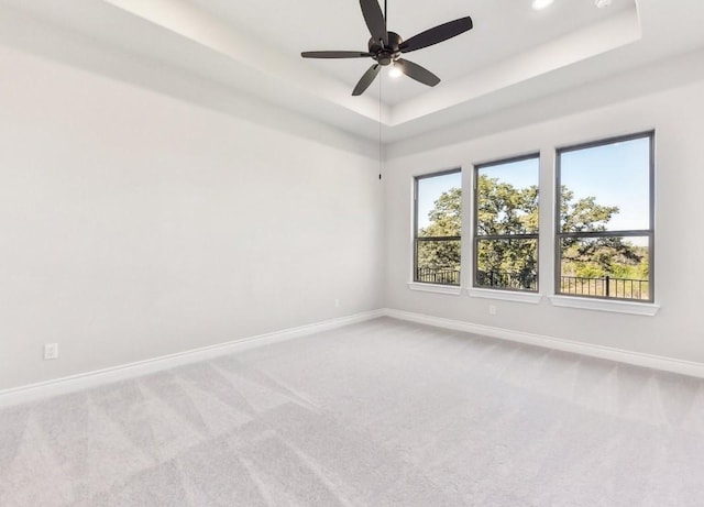 226 Flora Springs Cv, Liberty Hill, TX 78642 - carpeted empty room featuring a raised ceiling, baseboards, a ceiling fan, and recessed lighting