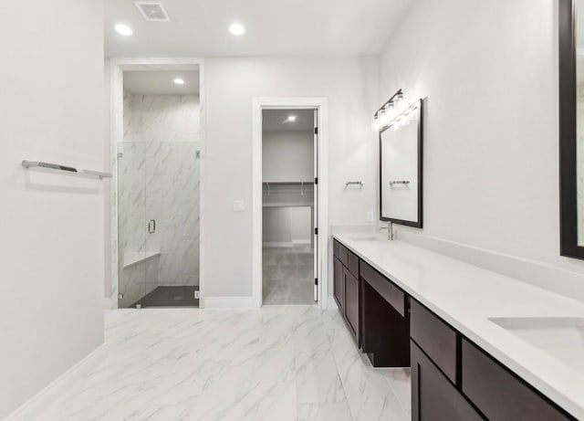 226 Flora Springs Cv, Liberty Hill, TX 78642 - full bathroom with marble look tiles, double vanity, a marble finish shower, recessed lighting, and a walk in closet
