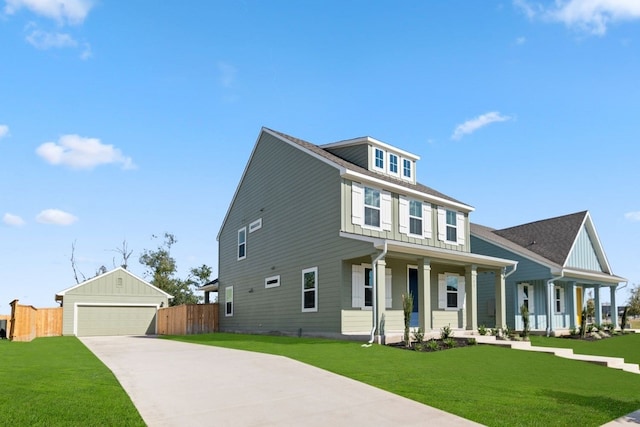 view of front of property featuring a garage, a front yard, an outdoor structure, and a porch