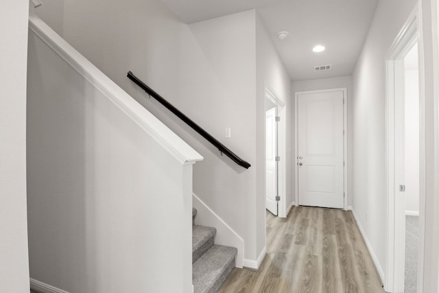 staircase featuring hardwood / wood-style flooring