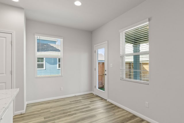 spare room featuring light hardwood / wood-style flooring