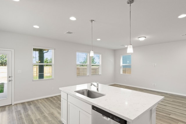 kitchen with hanging light fixtures, a healthy amount of sunlight, sink, and dishwasher