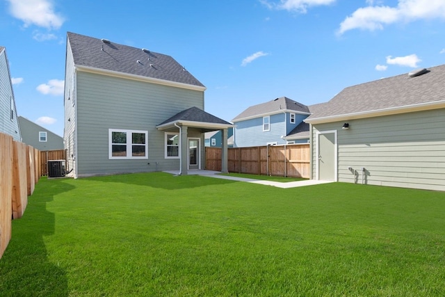 rear view of property featuring central air condition unit, a patio area, and a lawn