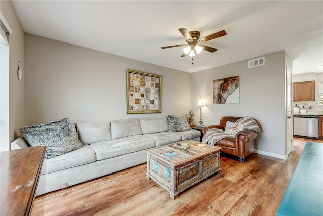 living room featuring wood-type flooring and ceiling fan