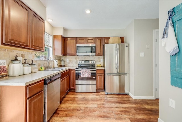 21461 Coyote Trl Unit 6, Lago Vista, TX 78645 - kitchen with stainless steel appliances, a sink, brown cabinets, decorative backsplash, and light countertops