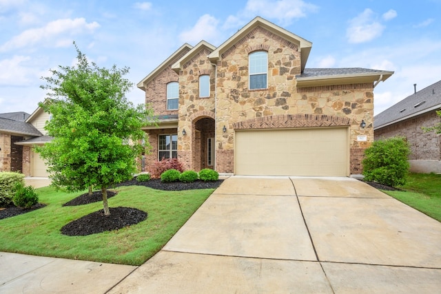 view of front of home featuring a front yard and a garage