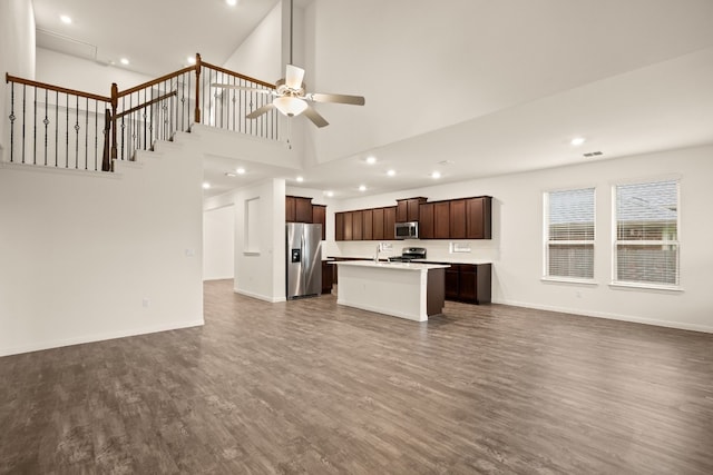 unfurnished living room featuring ceiling fan, sink, high vaulted ceiling, and dark hardwood / wood-style floors