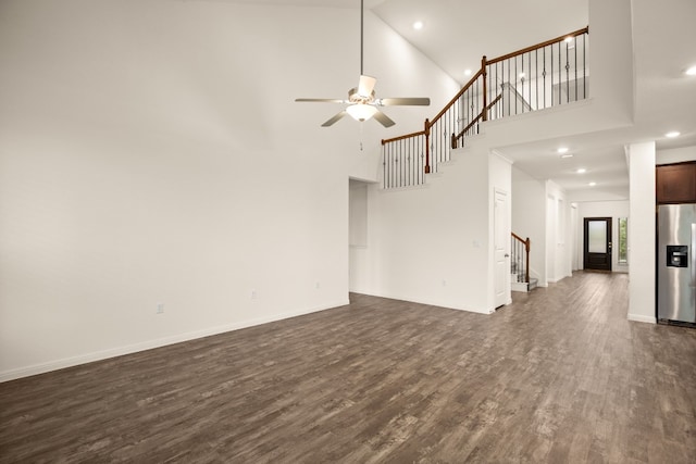 unfurnished living room with high vaulted ceiling, ceiling fan, and dark hardwood / wood-style flooring