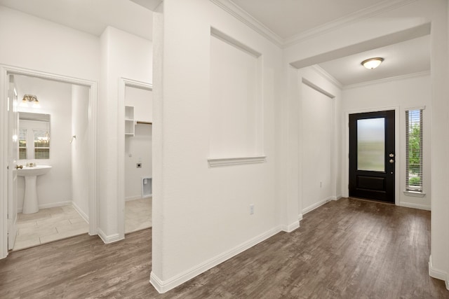 entryway featuring a wealth of natural light, dark hardwood / wood-style flooring, and crown molding