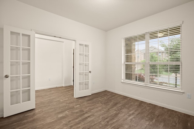 unfurnished room featuring dark hardwood / wood-style floors and french doors